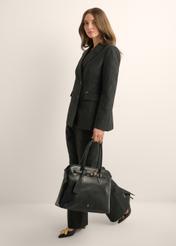 Large black women's handbag TOREC-1076-99(Z26), front view of the product in the model's hand. Full body visible.