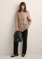 Black women's backpack TOREC-1253-9I(Z26), product view in model's hand. Full body visible.