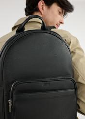 Black leather men's backpack TORMS-0450-99(W25), front view of the product on the model. Part of the silhouette visible.