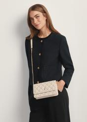 Small quilted women's handbag in cream TOREC-1150-0B(W26) - front view of the product, on a model, against a light background. Half-length silhouette visible.