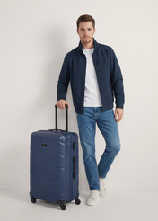 Medium suitcase on wheels WALAB-0077-7D-24(W26), product view from the front with the model, the whole silhouette visible.