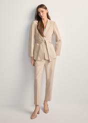 Beige women's pleated trousers SPODT-0090-1B(W26), front view of the product on the model. Full body visible.