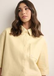 Short light yellow women's leather shirt KOSDS-0005-2A(W26), close-up of the product on the model's silhouette.