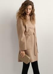 Beige small women's handbag TOREC-1126-1D(W26), product view in model's hand. Half of silhouette visible.