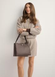 Brown women's shoulder bag TOREC-1297-1I(Z26), diagonal view of the product on the model. Half of the silhouette visible.