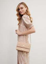 Beige women's monogram handbag TOREC-0536C-81(Z25), product view on model's shoulder. Half of silhouette visible.