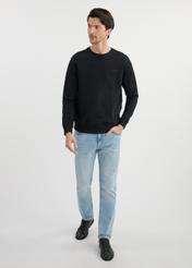 Black men's sweatshirt without hood BLZMT-0070-99(W25) - front view on the model on a white background. The entire silhouette is visible.
