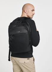 Men's black backpack with laptop compartment TORMN-0264C-99(Z25), product view on model. Half silhouette visible.