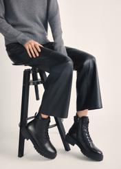 Black leather ankle boots BUTYD-1104-99(Z25), product view on model's feet against a light background.