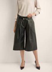 Women's wide-leg black leather trousers SPODS-0049-99(Z26) - front view of the product, on a model, against a light background. Half of the silhouette visible.