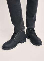 Black leather lace-up men's ankle boots BUTYM-0514-99(Z25) - front product view on model against white background. Close-up.