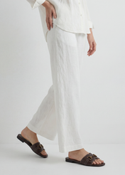 Women's dark brown leather slides BUTYD-1273-1I(W26), side view of the product on the model's feet. Half of the silhouette visible.