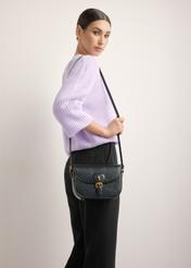 Small black women's messenger bag with decorative clasp TOREC-1243-9F(Z26), front view on model. Full body visible.