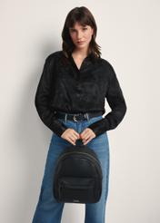 Black spacious women's backpack TOREC-1089-99(Z25) - front view of the product on a model against a white background. Knee-length silhouette visible.