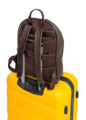 Dark brown leather men's backpack TORMS-0458-89(Z25), product view on suitcase on white background.