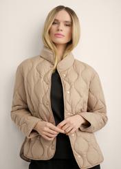 Women's short beige jacket KURDT-0689-1D(Z26), front view of the product on the model. Half of the silhouette visible.
