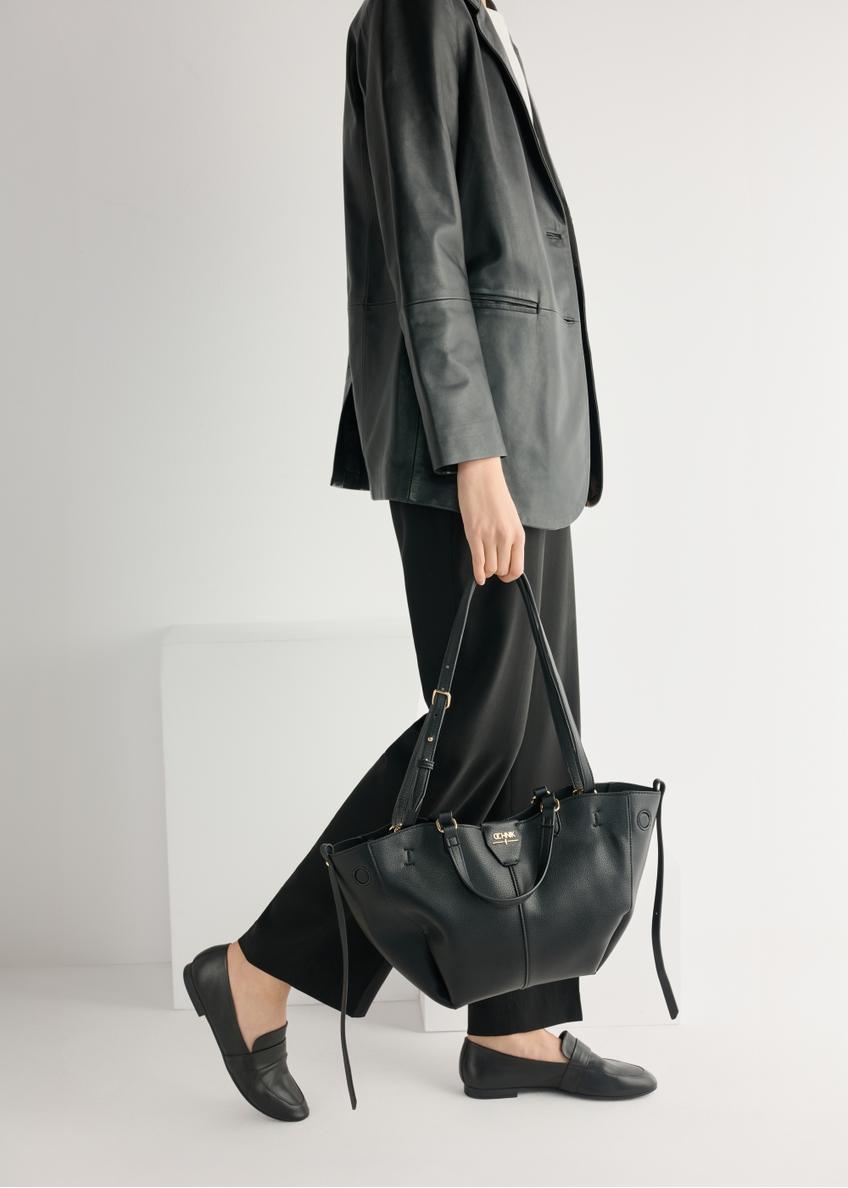 Women's black leather moccasins BUTYD-1074A-99(W26), product view from the front on the model, half of the silhouette visible.