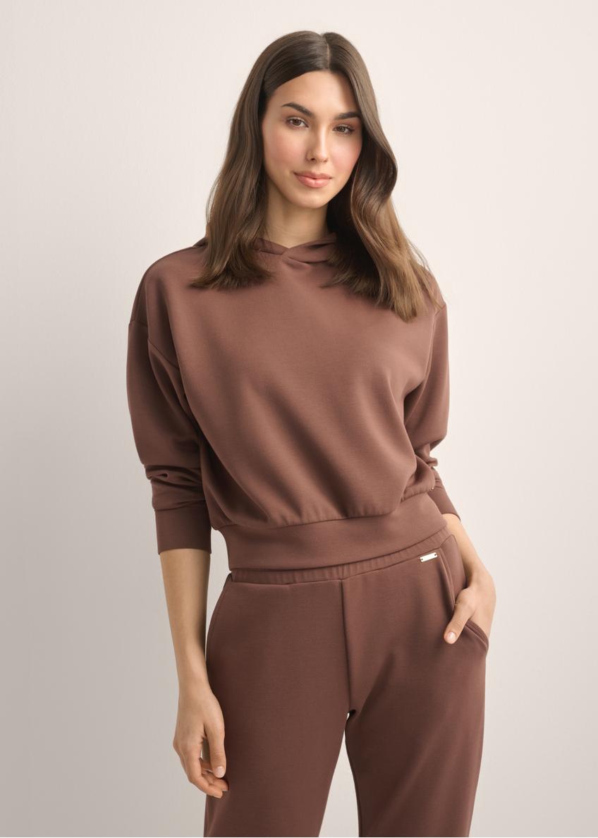 Women's brown hooded sweatshirt BLZDT-0118-1H(Z26), front view of the product on the model. Half of the silhouette visible.