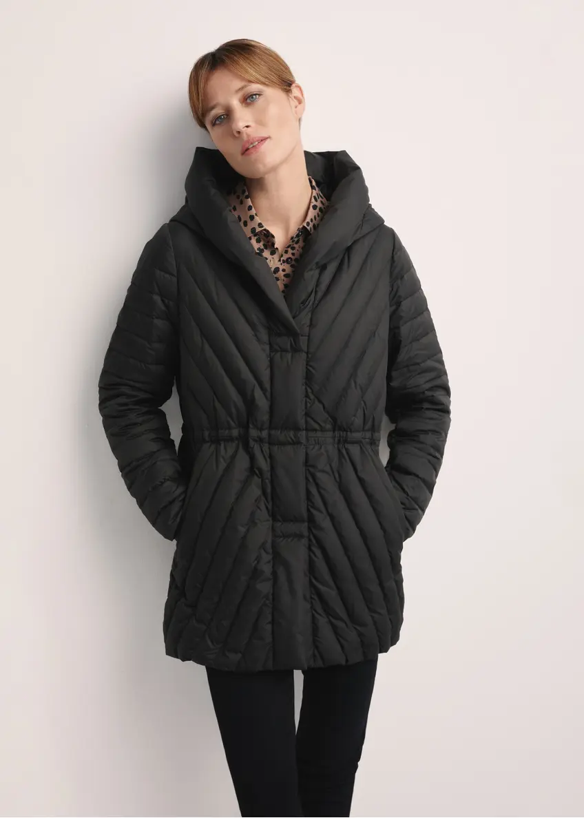 Black women's quilted jacket KURDT-0524-99(Z25), front view of the product on the model. Half of the silhouette visible.