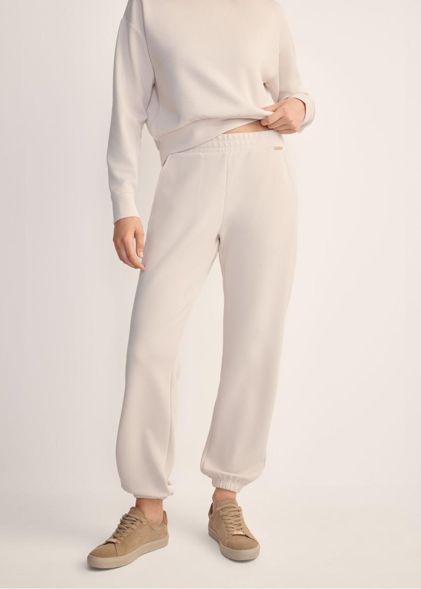 Light beige women's trousers SPODT-0117-80(Z25), front view of the product on the model. Half of the silhouette visible.