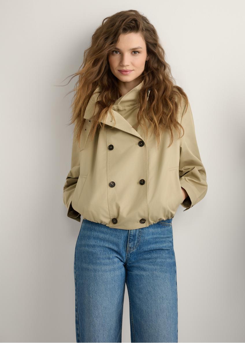 Beige women's short jacket KURDT-0657-1B(W26) - front view of the product, on a model, against a light background. Knee-length silhouette visible.