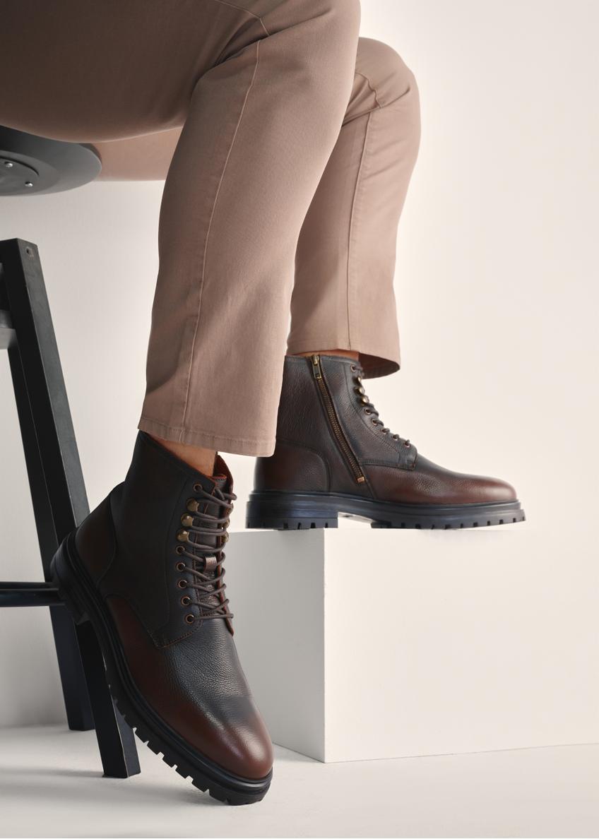 Brown men's leather ankle boots BUTYM-0518-09(Z25), product view on model's feet against a light background.