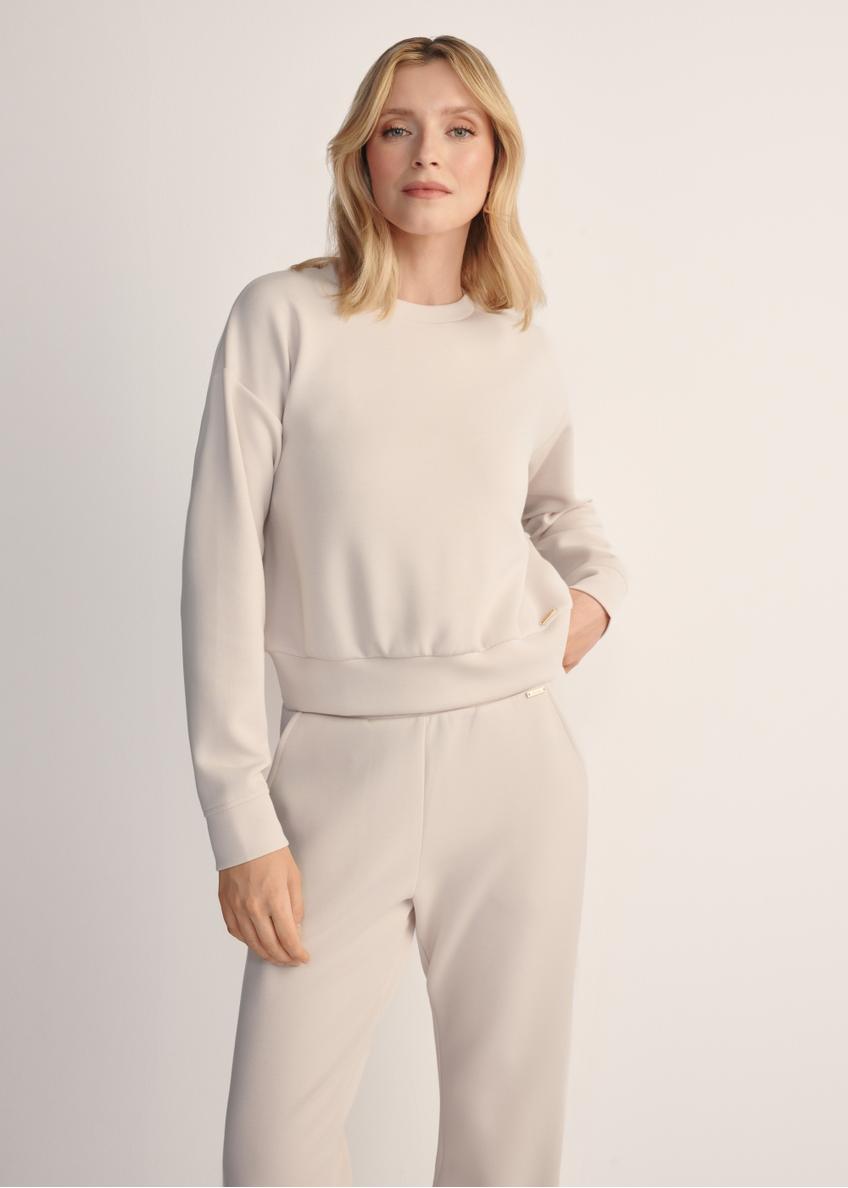 Light beige women's sweatshirt BLZDT-0119-80(Z25), front view of the product on the model. Half of the silhouette visible.