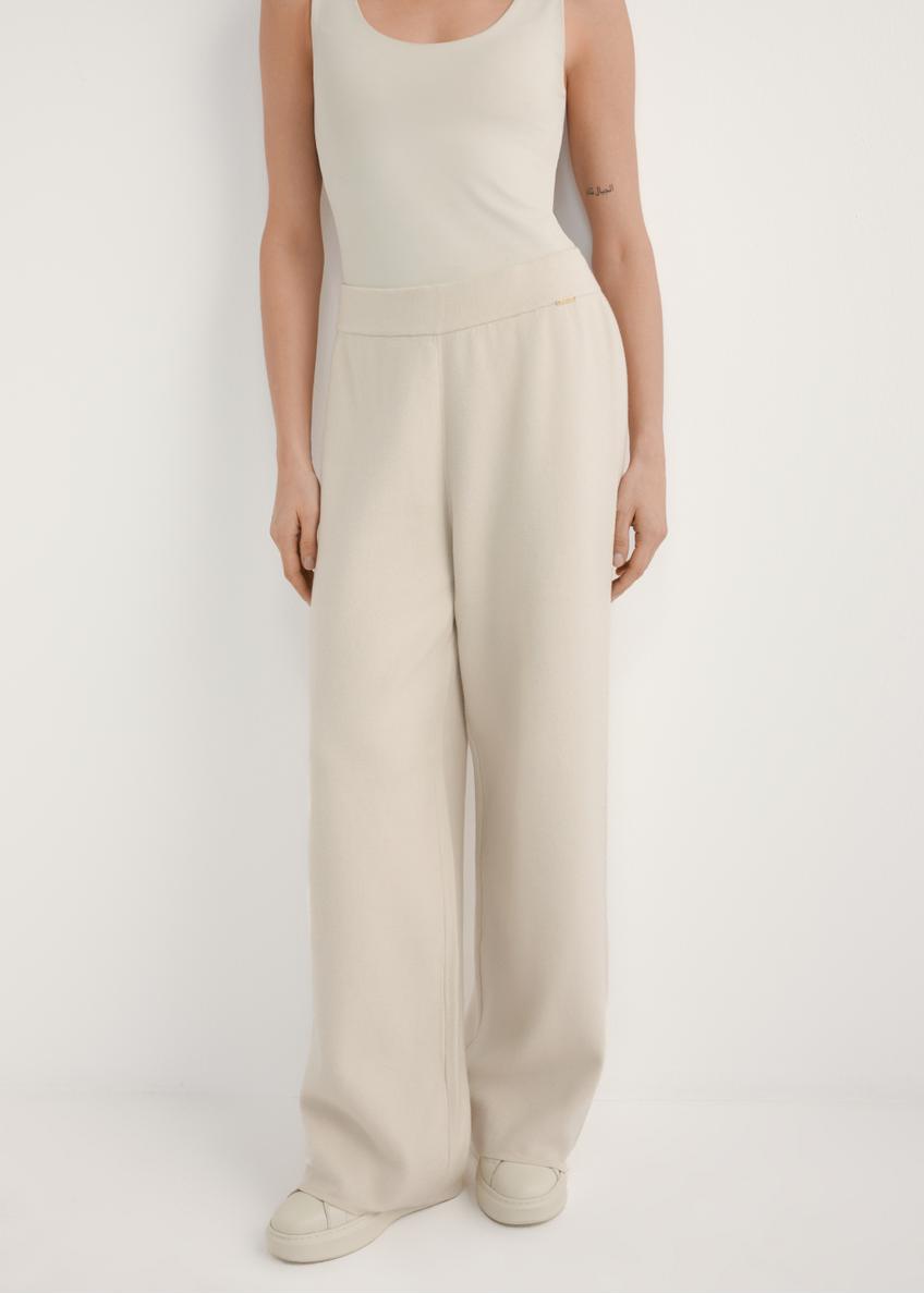 Beige women's wide leg trousers SPODT-0121-1A(W26), front view of the product on the model. Half of the silhouette visible.