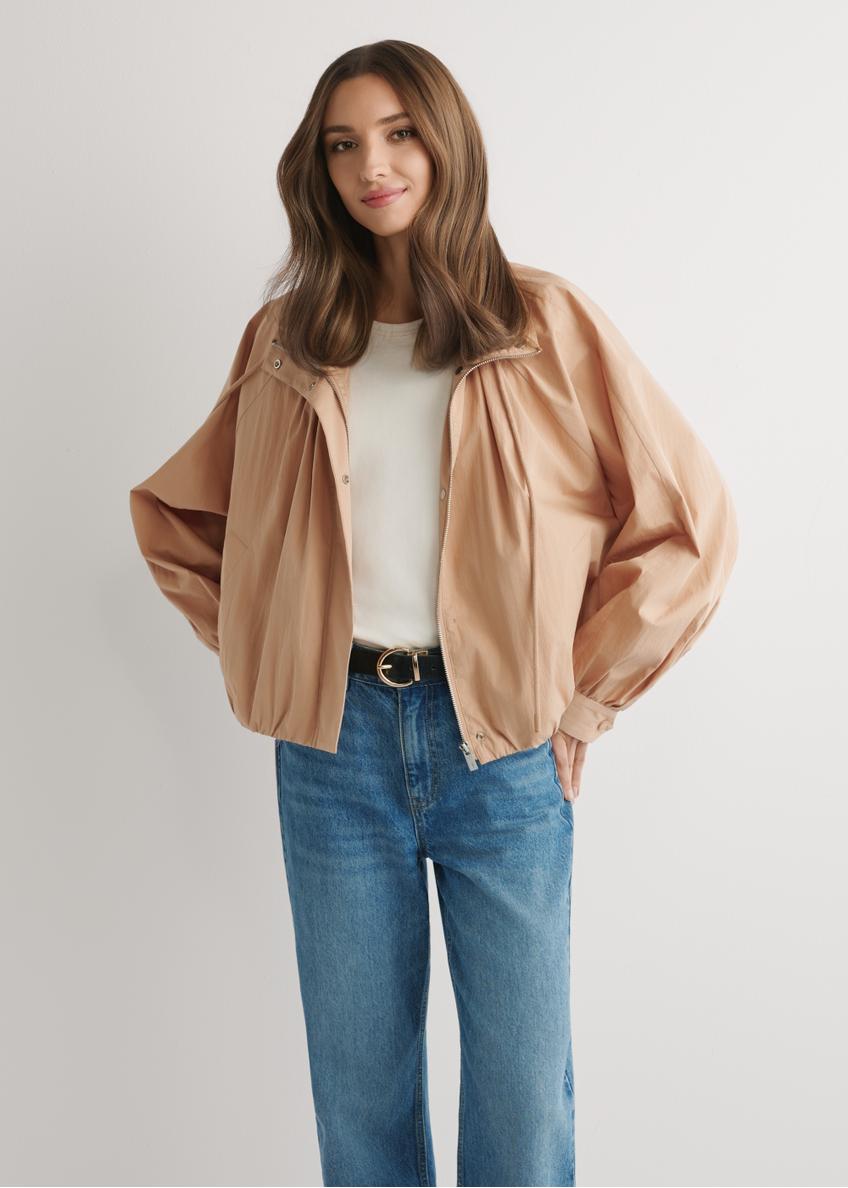 Beige short oversize women's jacket KURDT-0626-1D(W26) - front view of the product, on a model, against a light background. Knee-length silhouette visible.