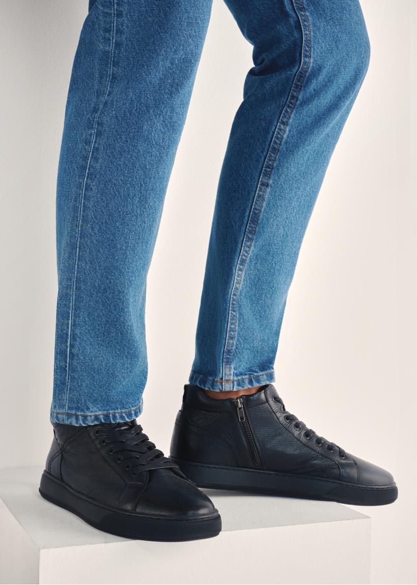 Black men's leather sneakers BUTYM-0466-99(Z25), product view on model's feet against a light background.