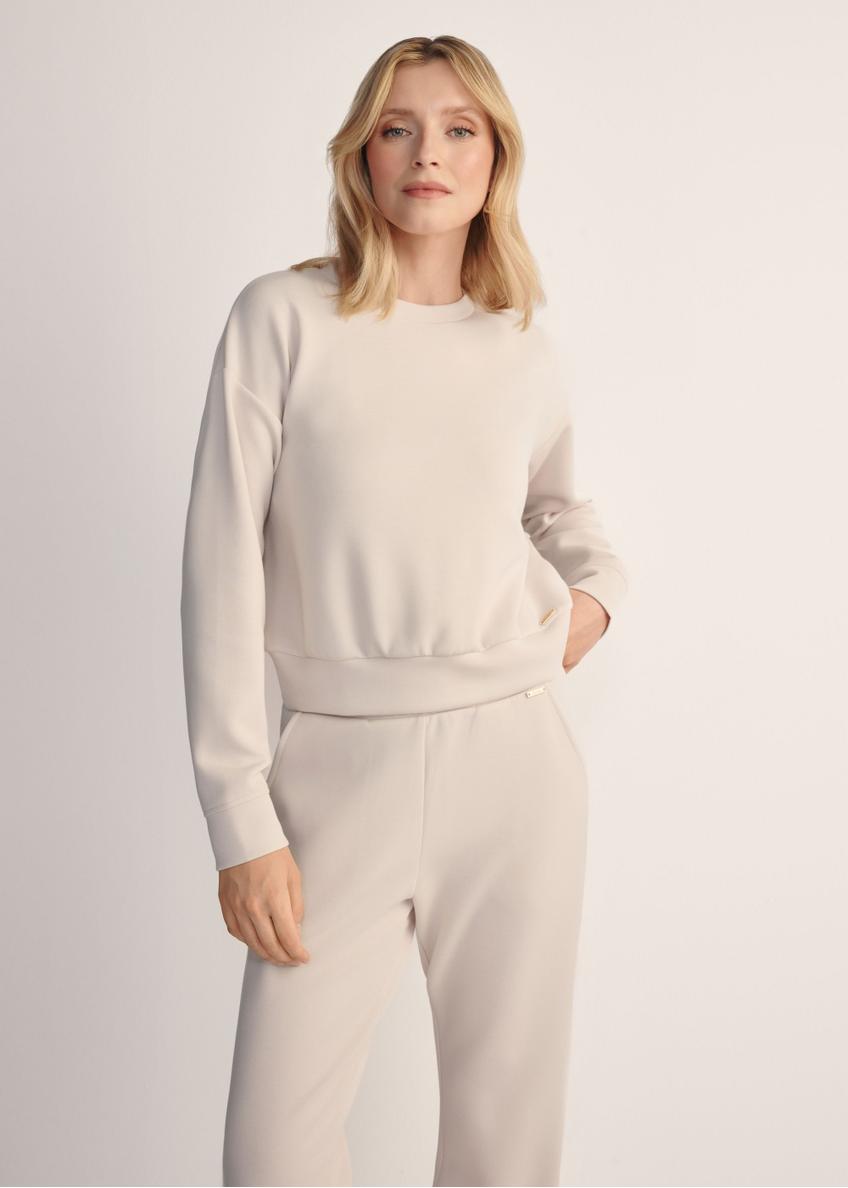 Light beige women's sweatshirt BLZDT-0119-1A(Z26), front view of the product on the model. Half of the silhouette visible.