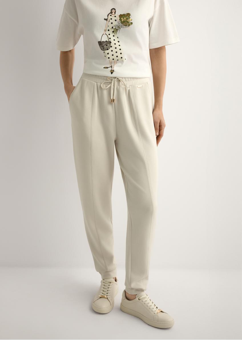 Light beige women's trousers SPODT-0108-1A(W26), front view of the product on the model. Half of the silhouette visible.