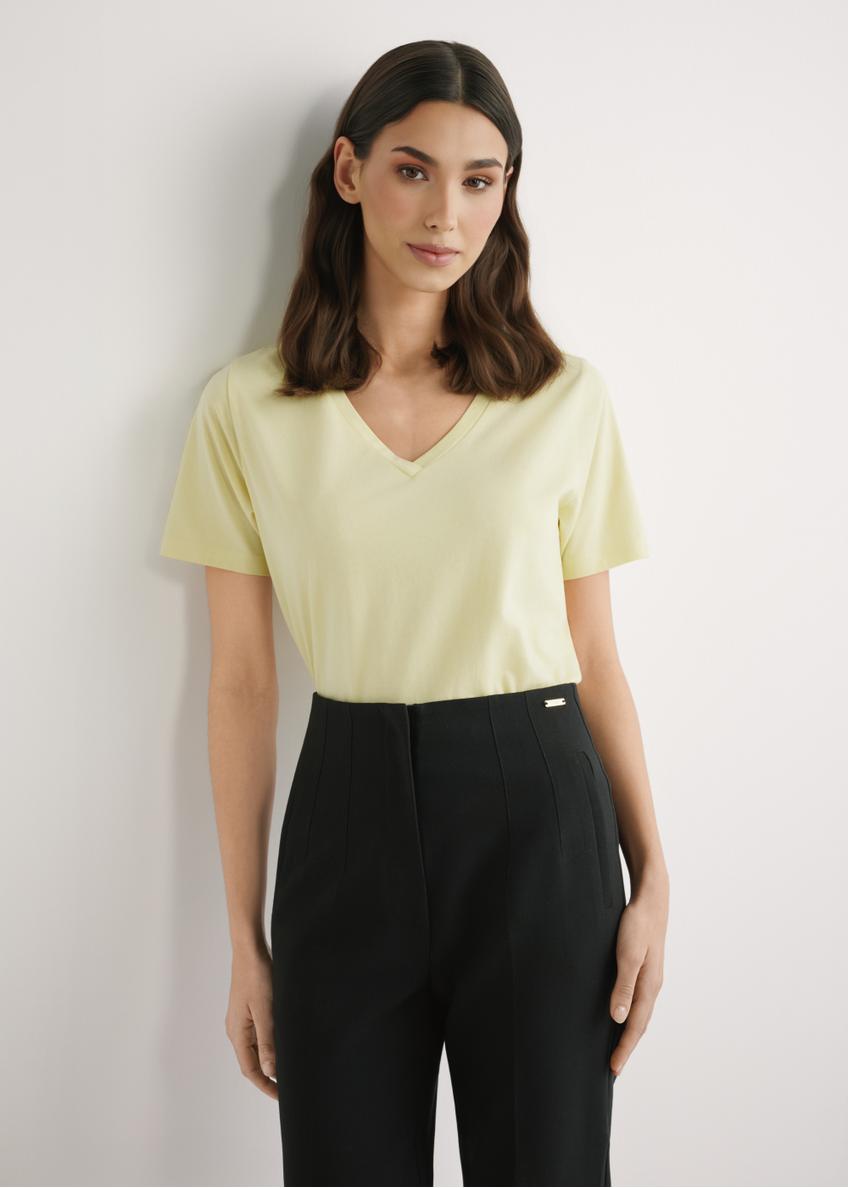 Light yellow women's basic T-shirt TSHDT-0120-2A(W26), front view of the product on the model. Half of the silhouette visible.