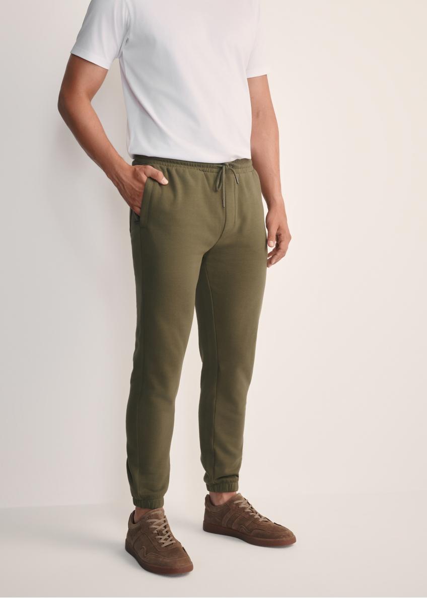 Men's khaki sweatpants SPOMT-0101-55(Z25), front view of the product on the model. Half of the silhouette visible.