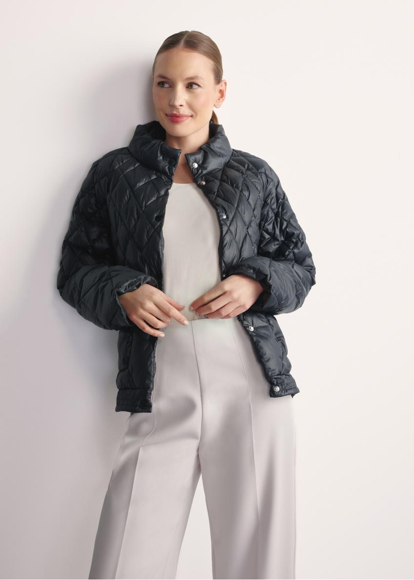 Black women's quilted jacket KURDT-0597-98(Z25), front view of the product on the model, half of the silhouette visible.