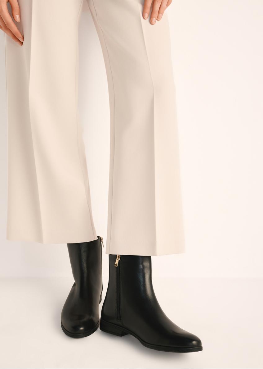 Black leather women's ankle boots BUTYD-1193-99(Z25), product view on model's feet against a light background.