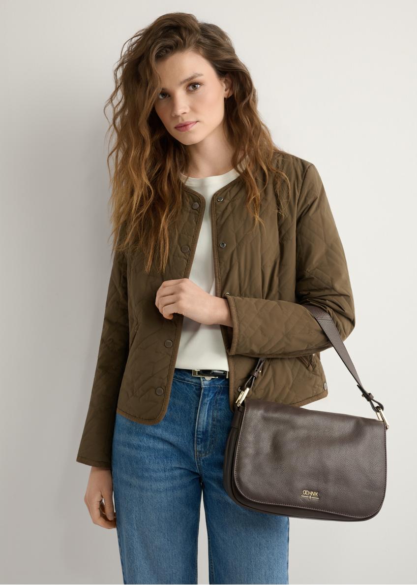 Women's brown leather messenger bag TORES-1253-1I(W26), product view on model's shoulder. Half silhouette visible.