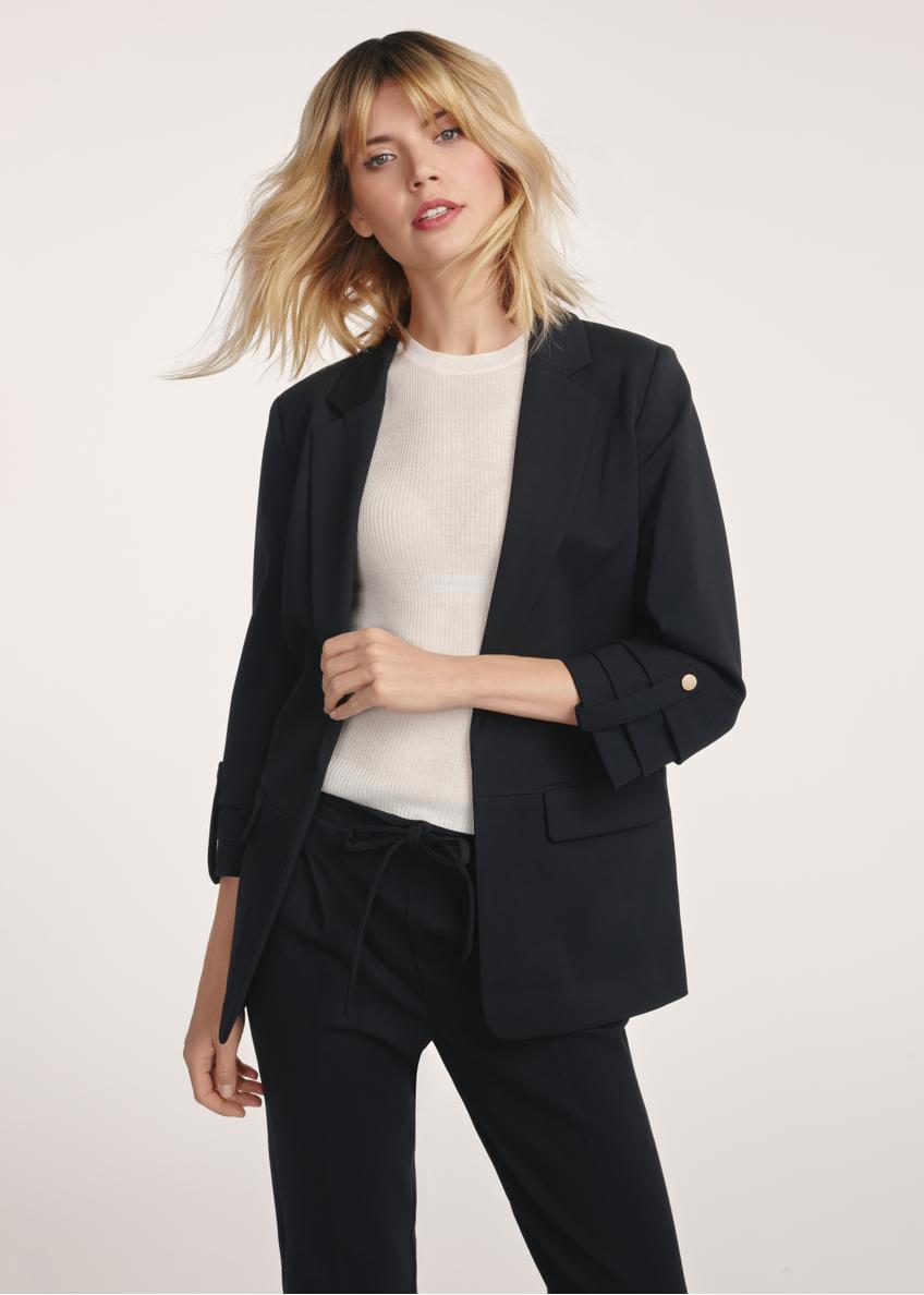 Black women's blazer without fastening ZAKDT-0034-99(Z24) - front view of the product on a model on a white background. Half of the silhouette visible.