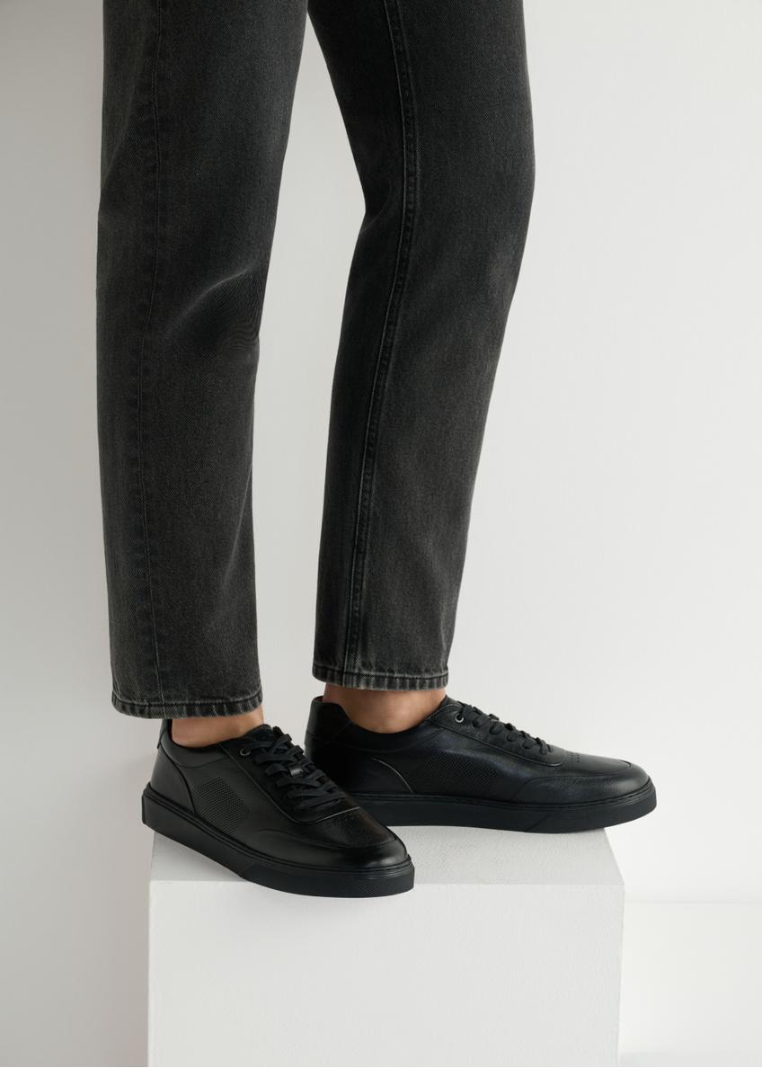 Black leather men's sports shoes BUTYM-0484-99(W25), side view of the product on the model, half of the silhouette visible.