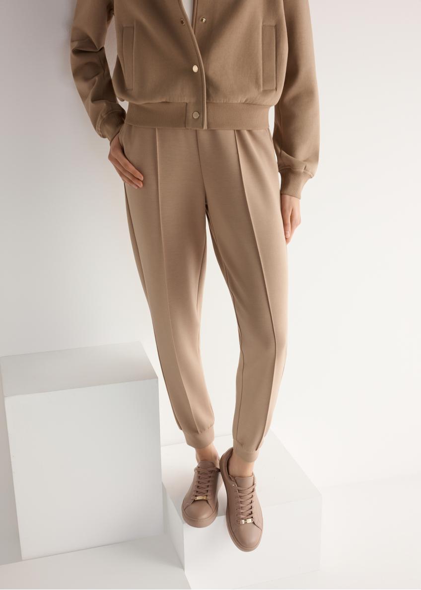 Women's pink leather sneakers BUTYD-1068-5D(W26), product view from the front on the model, half of the silhouette visible.