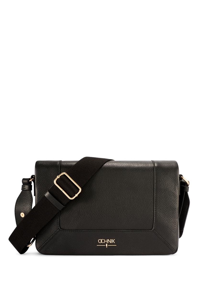 Black leather messenger bag TORES-1266-9I(W26) - front view of the product, on a model, on a light background.