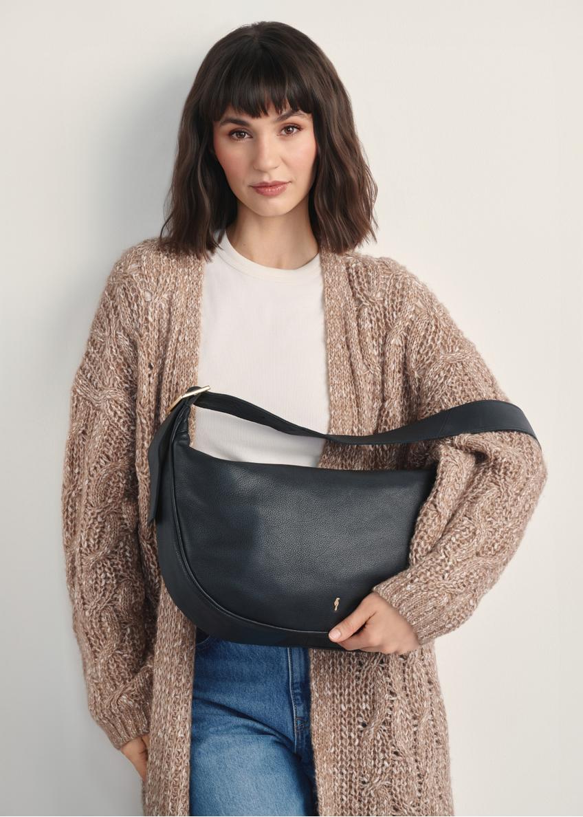 Black leather shoulder bag TORES-1127E-99(Z25), front view of the product on a model, half of the silhouette visible.