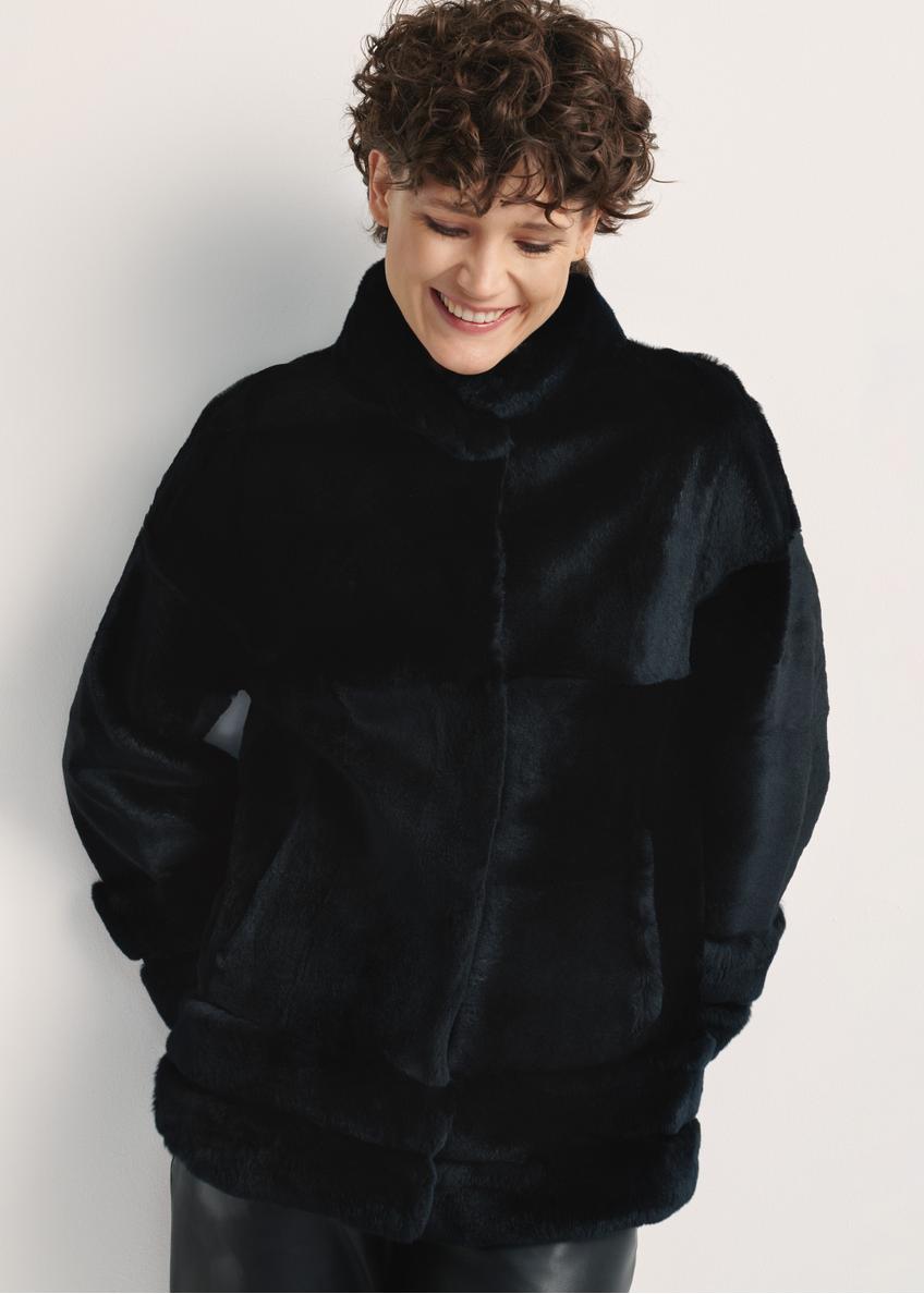 Black women's fur coat with a stand-up collar, natural FUTDF-0077-0984(Z24), front view of the product on a model, half of the silhouette visible.