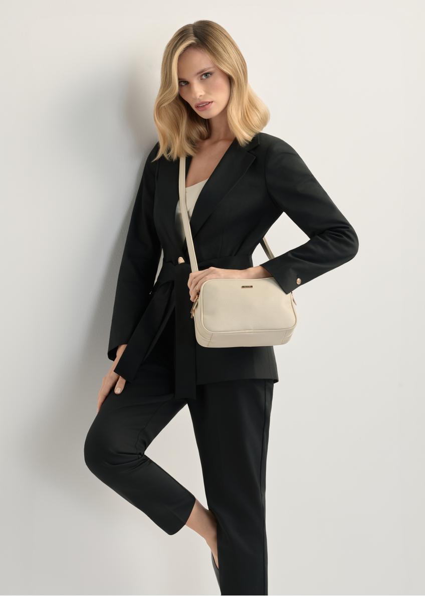 Cream medium women's handbag TOREC-1121-0B(W26), product view on model's shoulder. Half of silhouette visible.