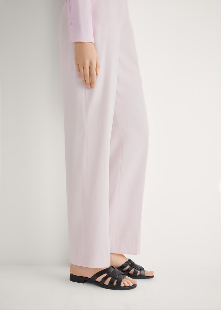 Women's leather flip-flops in black BUTYD-1266-99(W26), side view of the product on the model's feet.