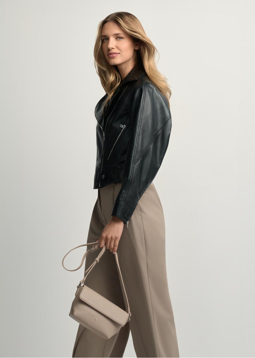 Beige small women's shoulder bag TOREC-0916-1A(W26) - front view of the product, held by the model, against a light background. Knee-length silhouette visible.