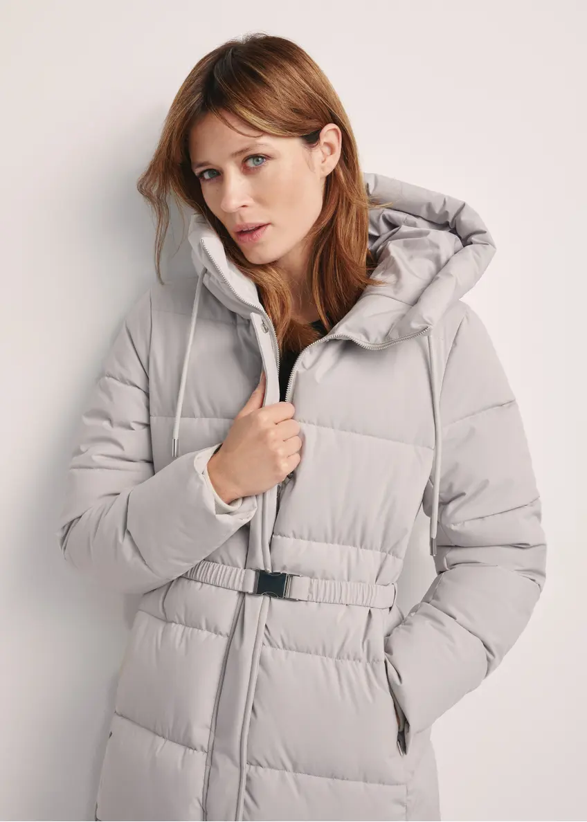 Long light gray women's jacket KURDT-0602-66(Z25), front view of the product on the model. Half of the silhouette visible.