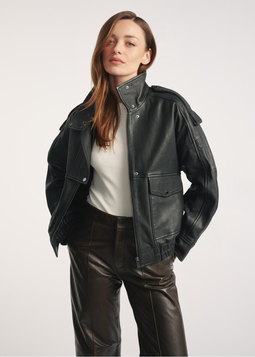 Women's black leather jacket KURDS-0554-2701(Z25) - front view of the product on a model, against a white background. Knee-length silhouette visible.