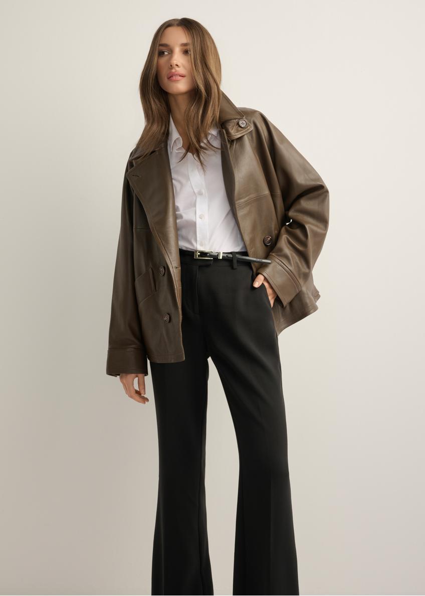 Women's oversize brown leather jacket KURDS-0592-1K(Z26), front view of the product on the model, half of the silhouette visible.
