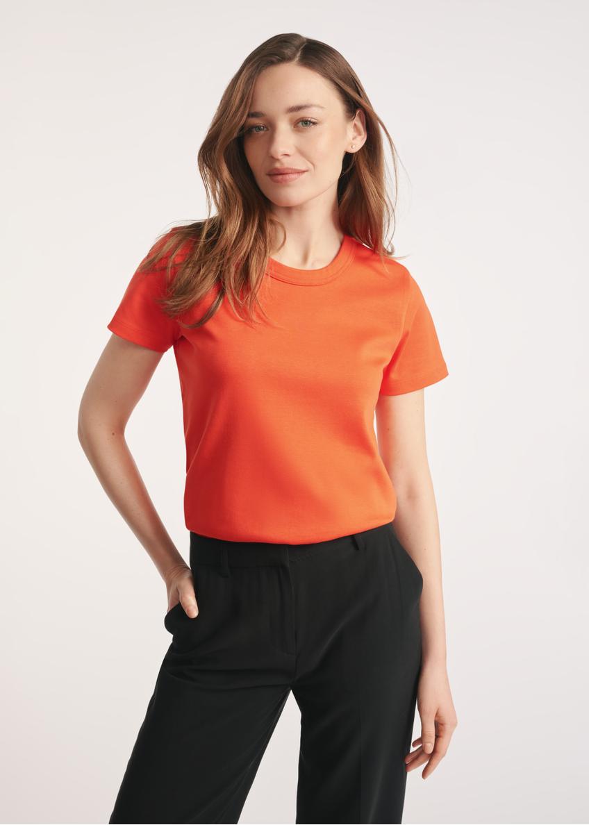Orange cotton women's T-shirt TSHDT-0144-30(Z25) - front view of the product on a model on a white background. Half of the silhouette visible.